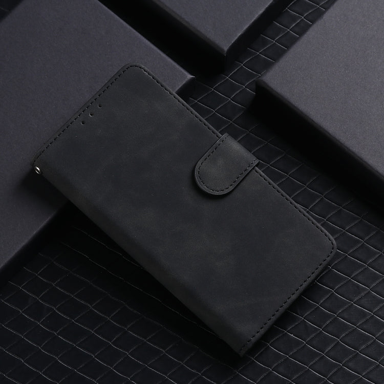 Black leather flip phone case close-up: stitched flap, strap, and card pocket.
