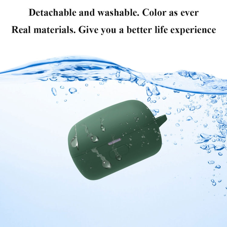 Green silicone earbud case floating in water, showing washable design