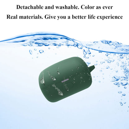 Green silicone earbud case floating in water, showing washable design