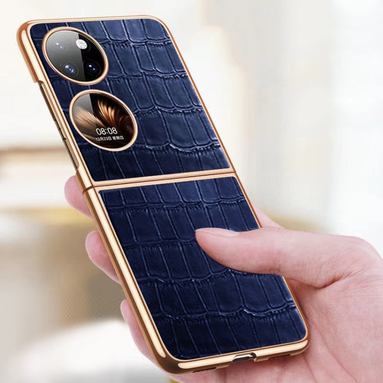 Blue crocodile-texture folding phone case held in hand, showing dual camera openings