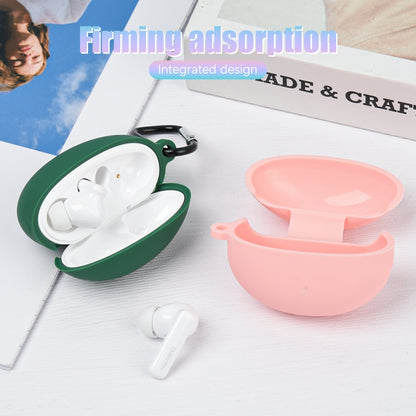 Dark green and pink liquid silicone earbud cases, open with earbuds inside