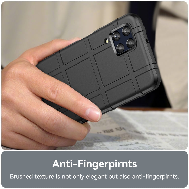 Black shockproof TPU phone case in hand, textured back and camera openings