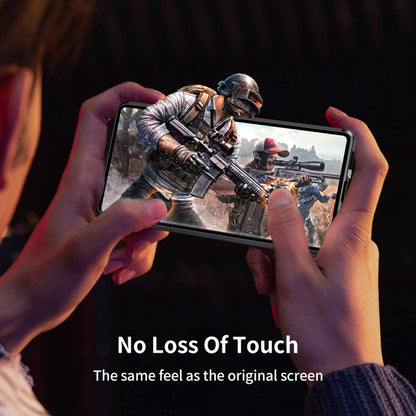 Tempered glass phone case on a smartphone, hands holding the device