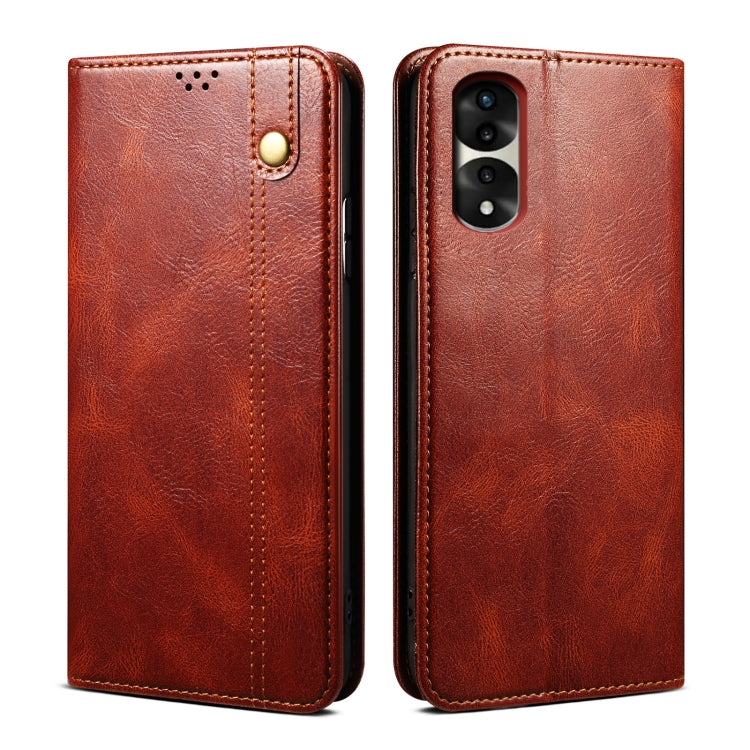 Brown leather phone case with magnetic clasp, stitched edges, and camera cutout