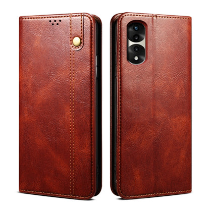 Brown leather phone case with magnetic clasp, stitched edges, and camera cutout