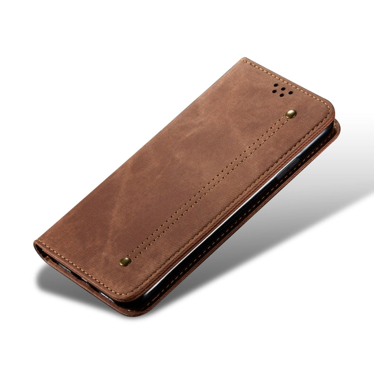 Brown denim-texture flip phone case, closed with stitched panel and snap button.