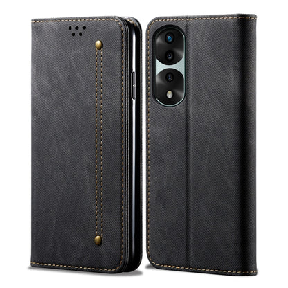 Black denim-textured leather flip phone case with stitched corners and snap strap