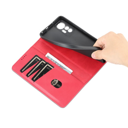 Red leather-style wallet phone case with card slots, hand lifting back cover