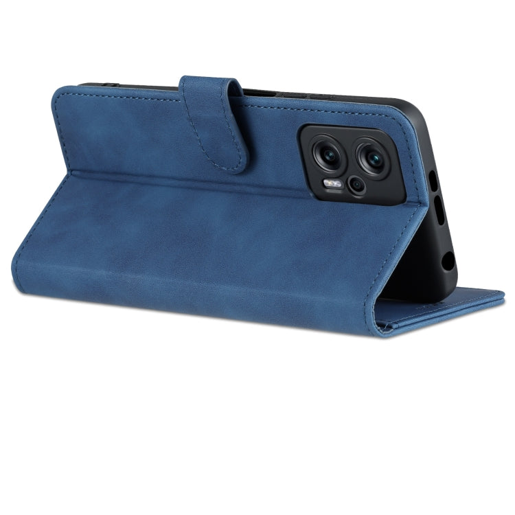 Blue leather flip phone case with top flap and camera cutout, cover open in stand position