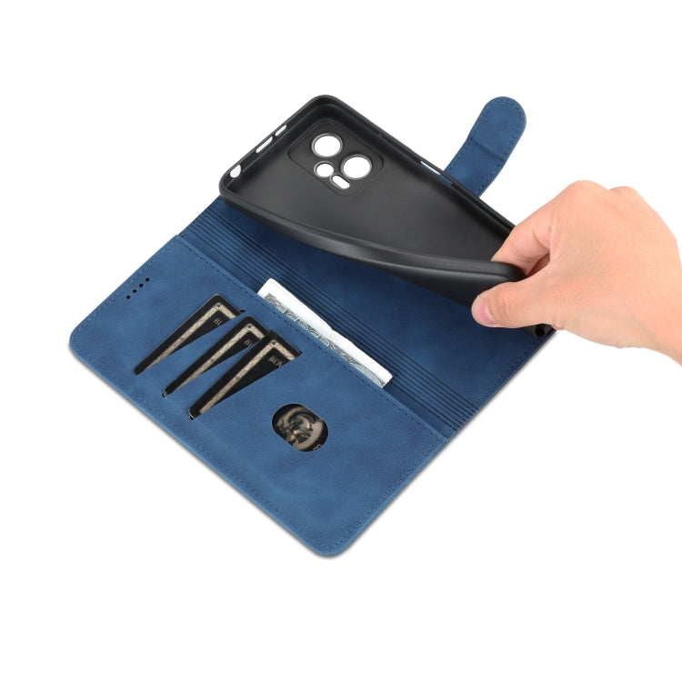Blue leather flip phone case with exposed cards and hand opening the cover