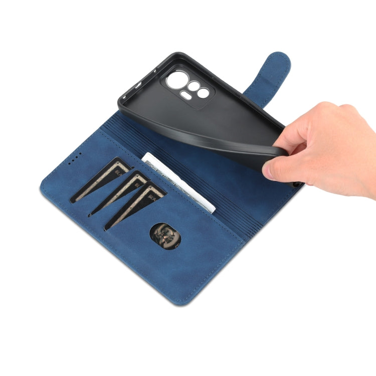Blue flip leather phone case with card slots, opened with hand lifting cover