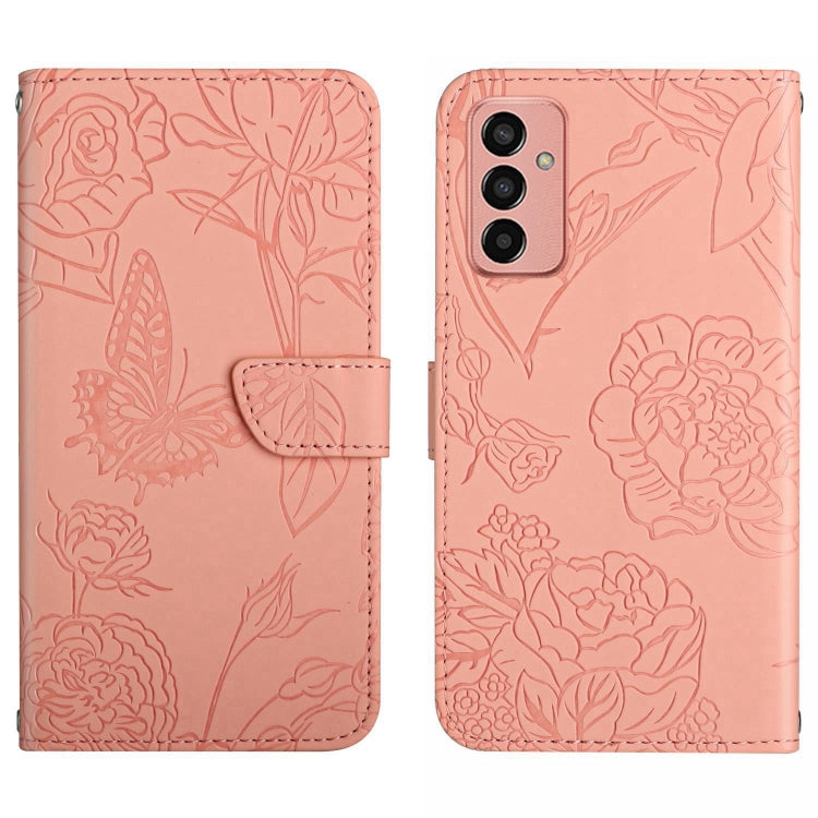 Pink butterfly embossed flip leather phone case with strap and triple camera cutouts