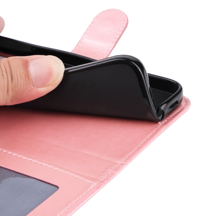 Pink leather folio phone case close-up with stitched flap edge and folded stand