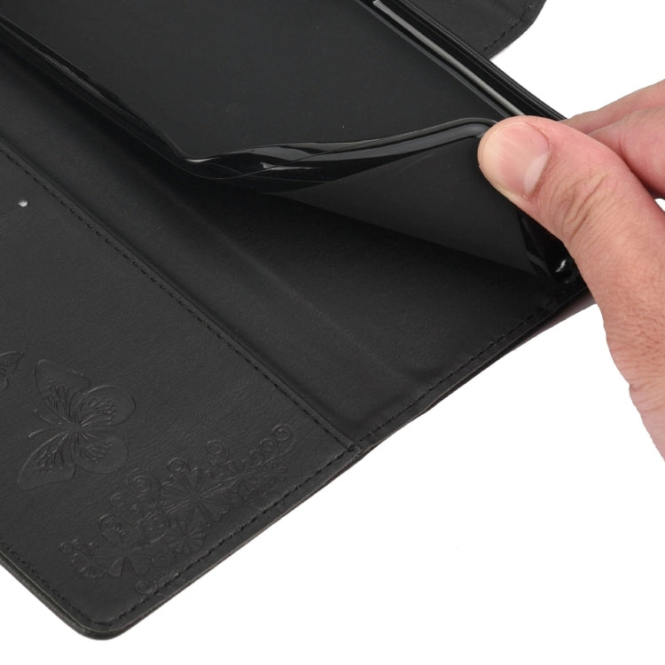Black leather flip phone case corner with embossed butterfly pattern