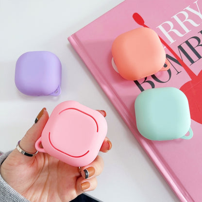 Pink frosted earphone case held in hand with small carrying loop