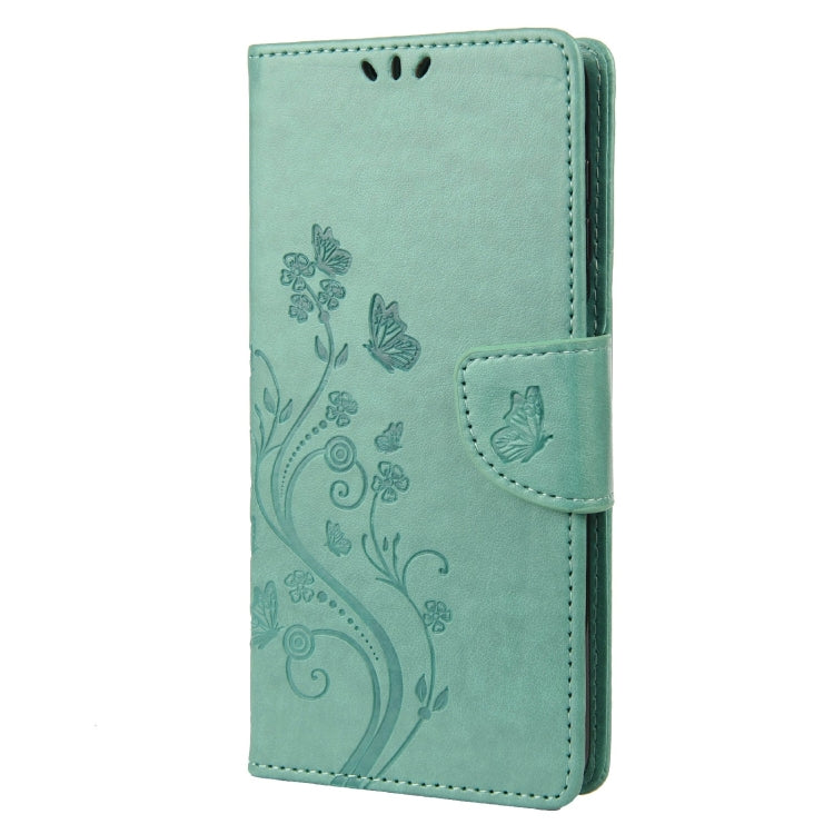 Green leather flip phone case with butterfly-flower pattern and card slot flap.