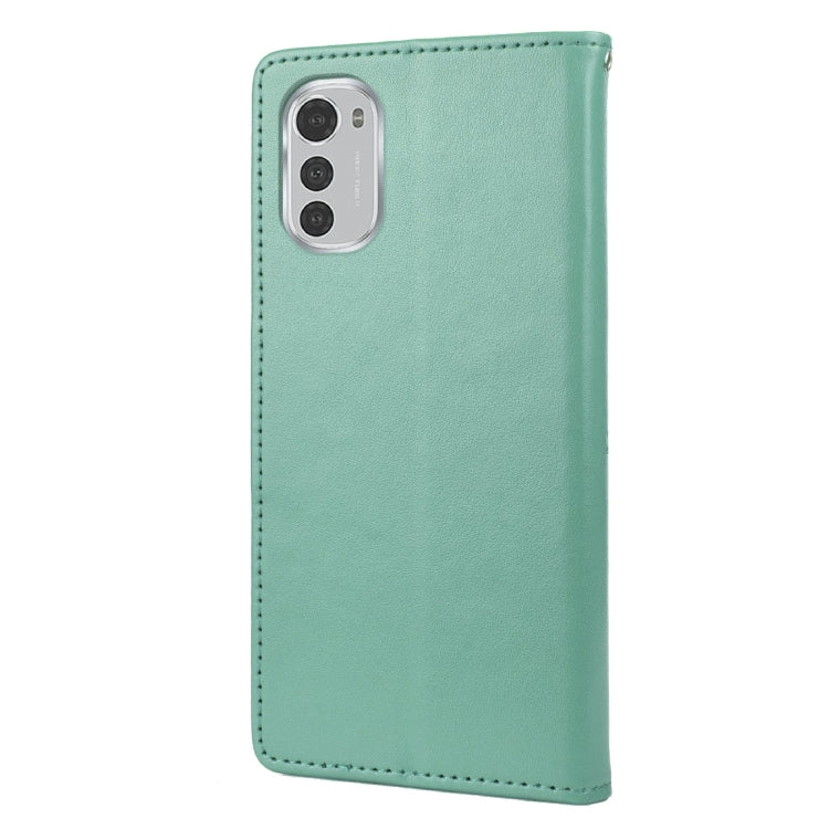 Green leather phone case with butterfly-flower pattern and camera cutouts.