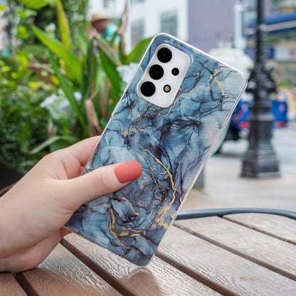 Blue marble TPU phone case with gold veins, clear border, camera cutouts