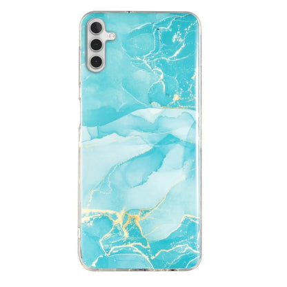 Aqua marble pattern TPU phone case with clear trim and cutouts for camera and ports.