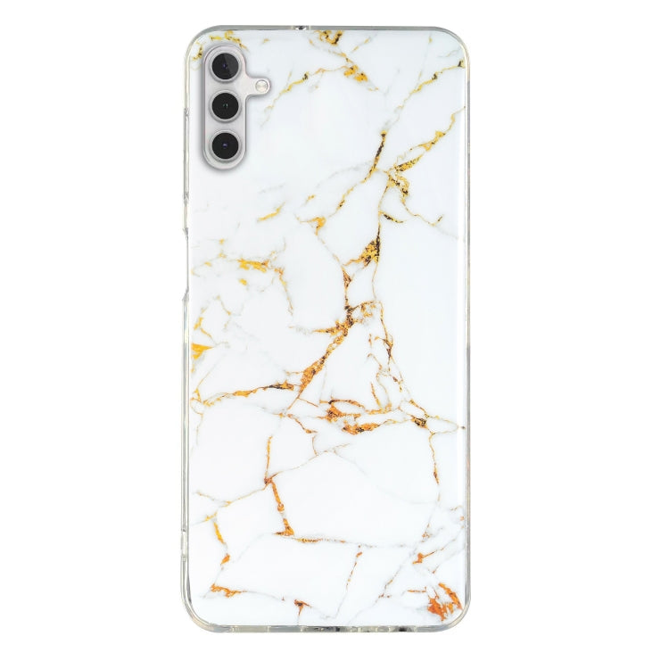 White marble pattern TPU phone case with gold veining and clear trim for camera and ports.