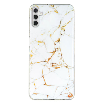 White marble pattern TPU phone case with gold veining and clear trim for camera and ports.