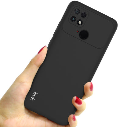 Black frosted TPU phone case for Xiaomi Poco C40, shown from back in hand