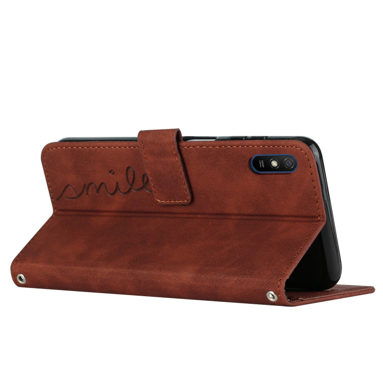 Brown leather folio phone case with heart pattern, wallet-style flip cover
