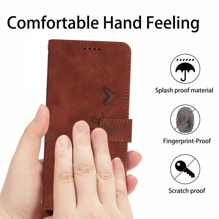 Brown leather phone case with heart pattern, front panel in close view