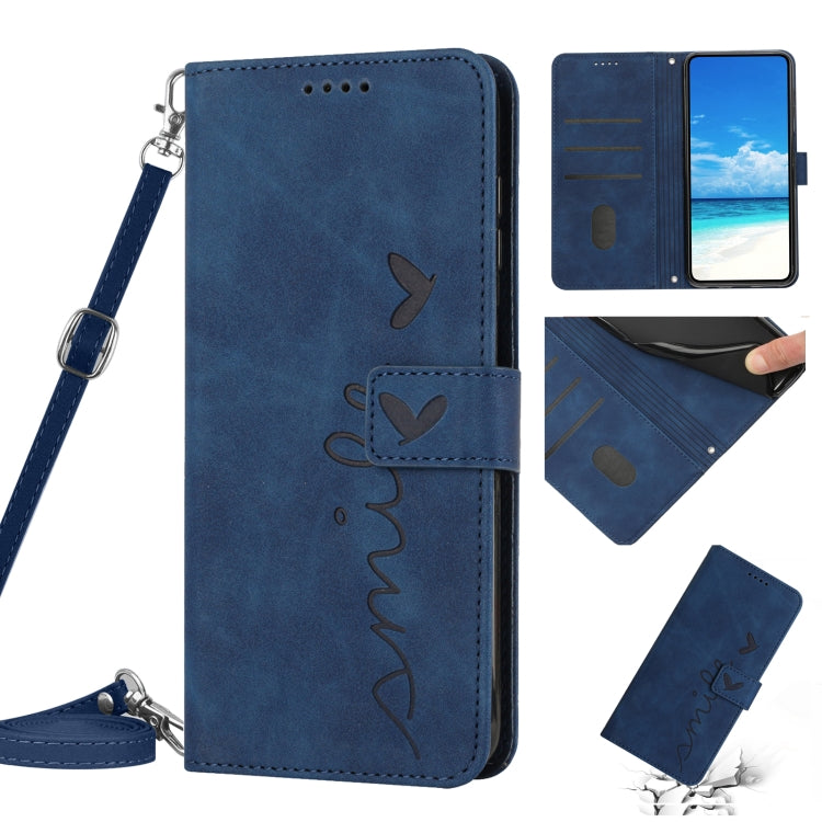 Blue leather phone case with heart pattern, wallet style, wrist lanyard.