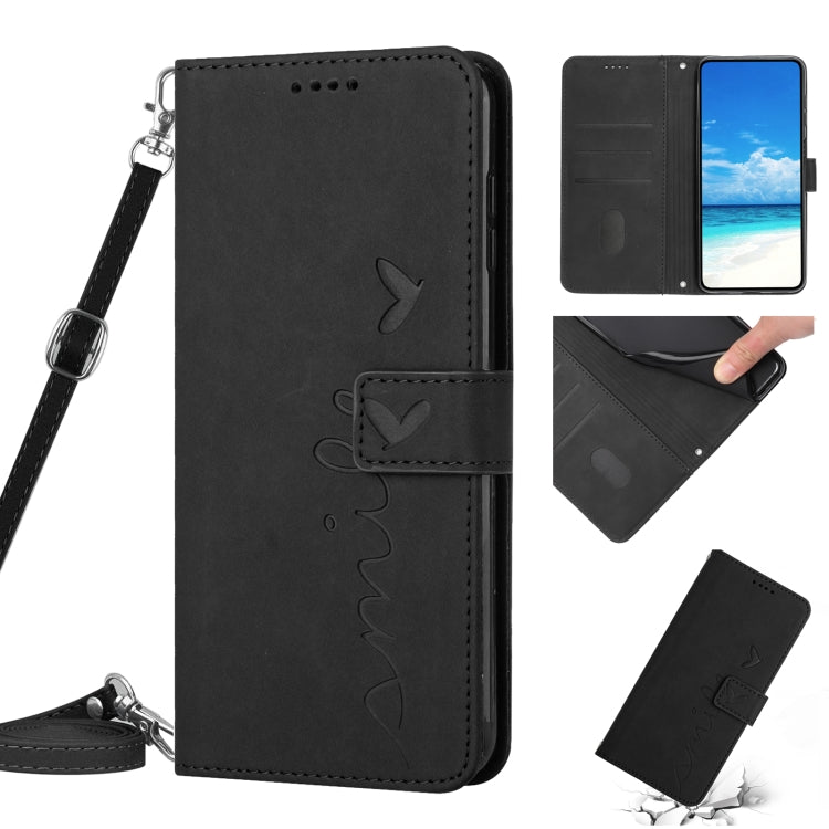 Black leather phone case with heart motif stitching and attached wrist lanyard strap