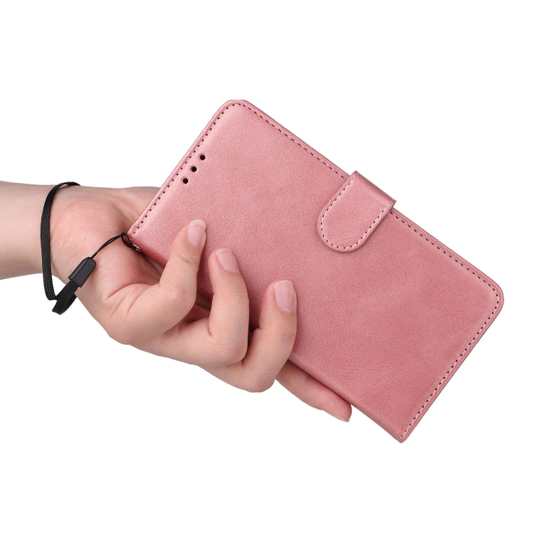 Pink leather folio phone case shown in hand with side snap strap