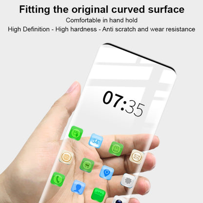 Tempered glass screen protector in hand, clear curved glass with rounded corners