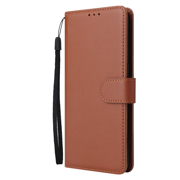 Brown leather wallet-style phone case with magnetic closure strap