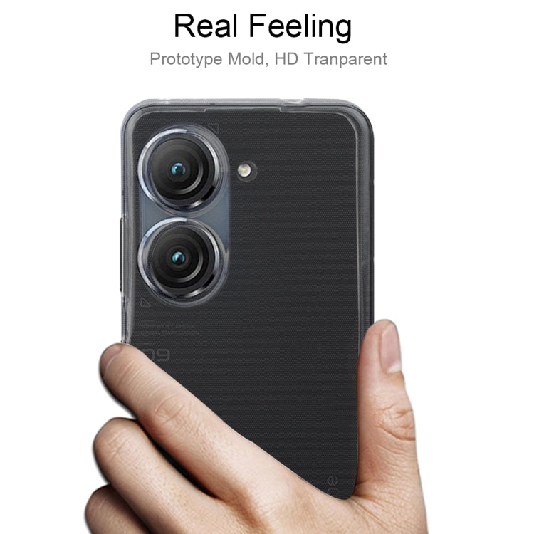 Transparent TPU phone case on a phone held in a hand, showing camera openings.