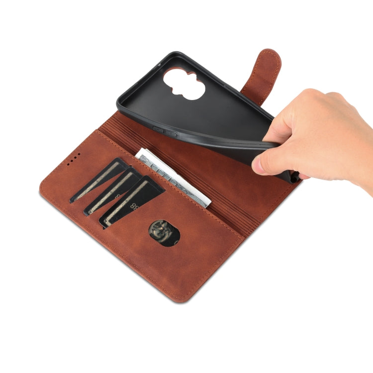 Brown leather flip phone case with open card slots and hand inserting items