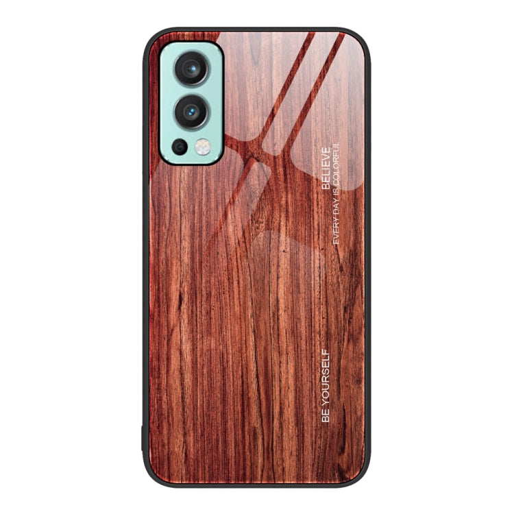 Wood grain glass phone case with dark red wood pattern, teal camera trim and black border