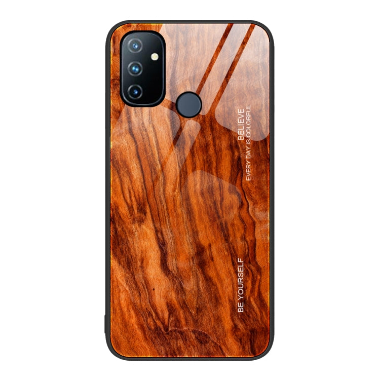 Wood grain glass phone case with orange wood pattern, black camera module and round flash cutout