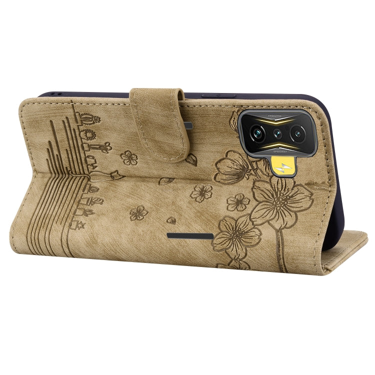 Beige embossed leather phone case with floral sakura cat design, side kickstand