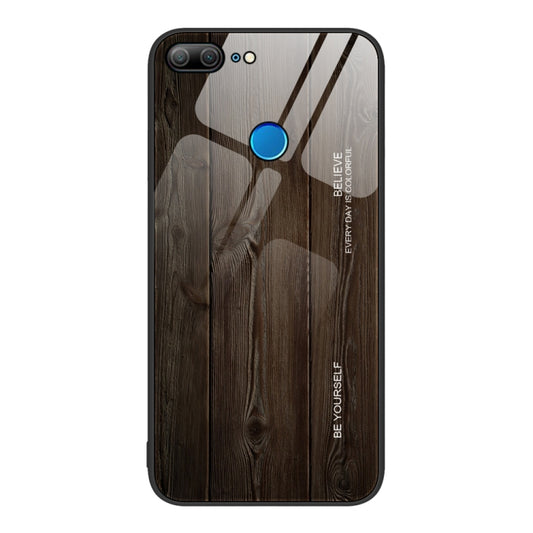 Wood grain glass phone case with dark brown wood pattern and blue accent button
