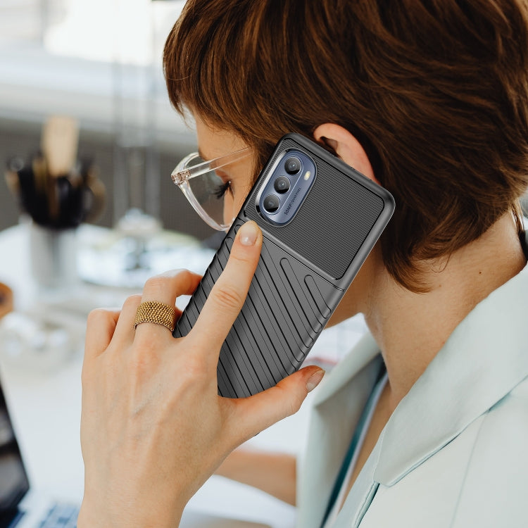 Shockproof TPU phone case for Motorola Moto G62 5G in use, textured grip and camera protection