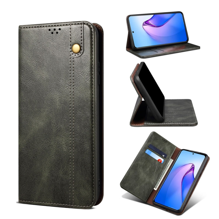 Dark green leather phone case with camera cutout, button strap, and stitched edges.