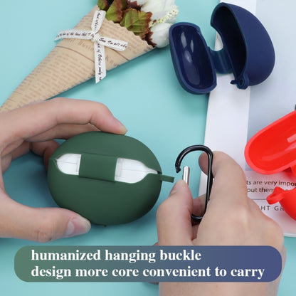 Green silicone earphone case with black carabiner loop, held by hands