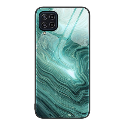 Marble pattern glass phone case with teal green marbled waves, camera cutouts