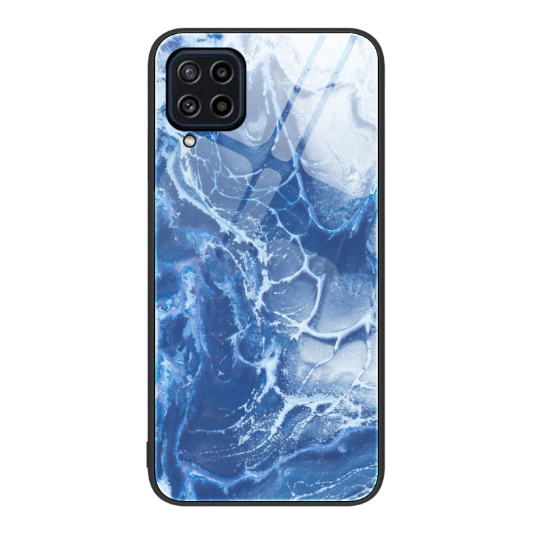 Marble pattern glass phone case with deep blue marbled waves, camera cutouts