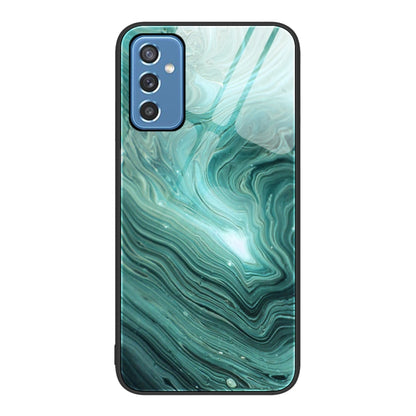 Marble glass protective phone case with teal wave pattern and camera cutouts