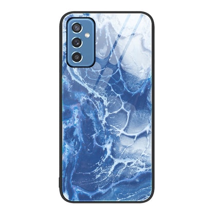 Marble glass protective phone case with blue ocean pattern and camera cutouts