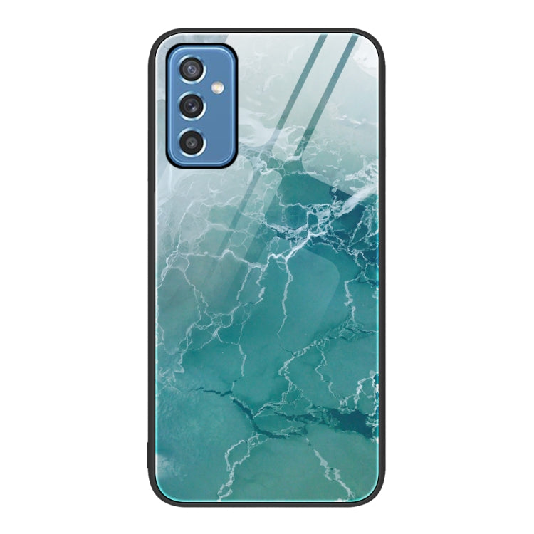Marble glass protective phone case with light teal marble pattern and camera cutouts