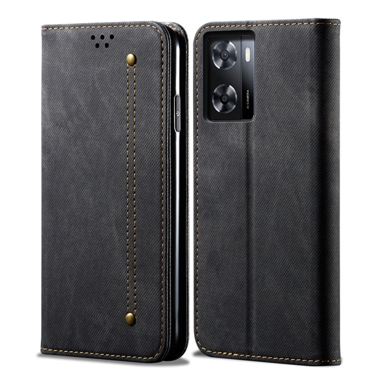 Black denim-textured flip phone case with gold stitching and camera cutout.