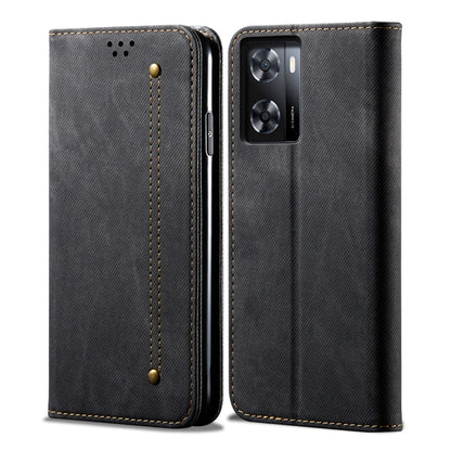 Black denim-textured flip phone case with gold stitching and camera cutout.