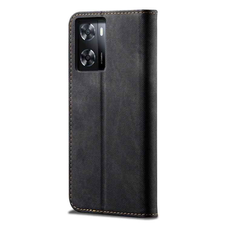 Black denim-textured flip phone case with camera cutout and gold-edged stitching.